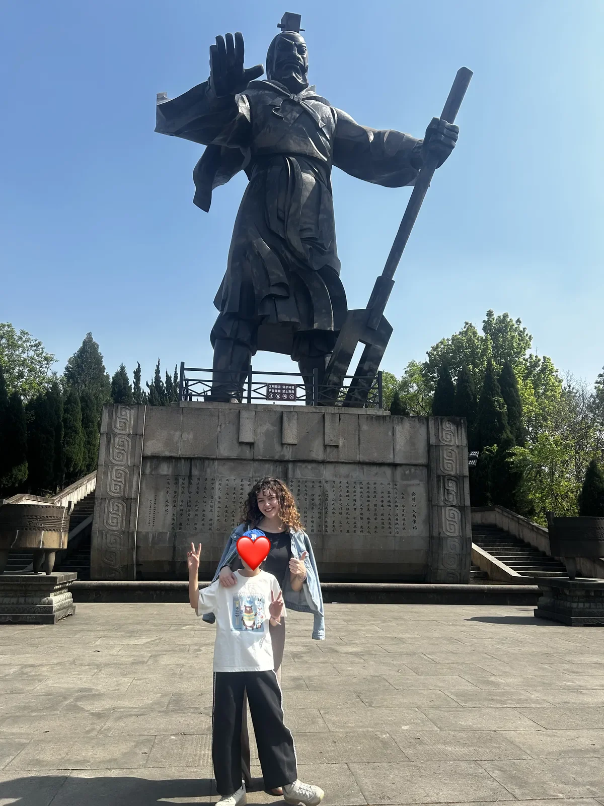 Davanti a una statua, in un parco di Hangzhou